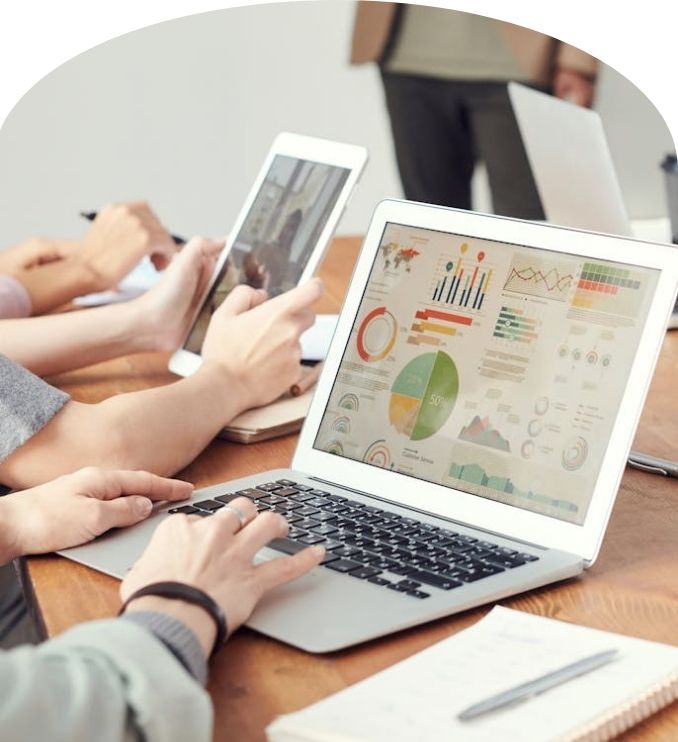 Team reviewing customer segmentation data and insights on laptop and tablet